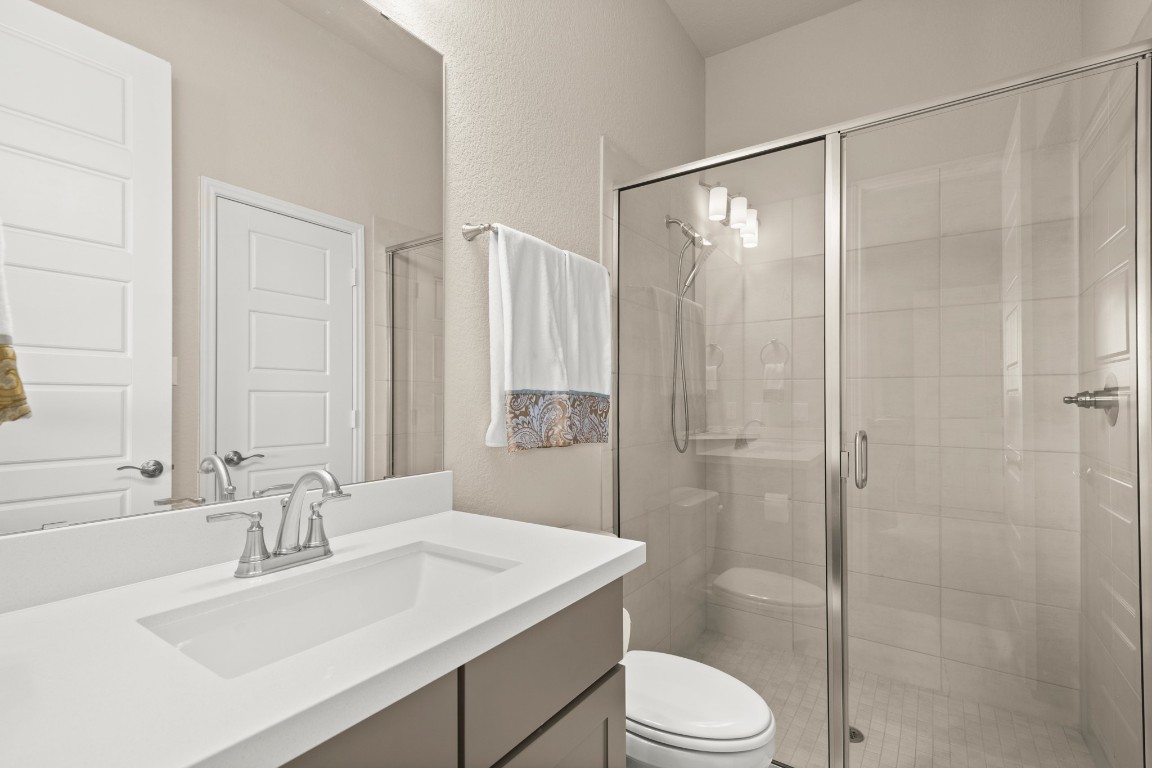 108 Rosetta Loop Liberty Hill, TX 78642 - Photo 16 of 40 a bathroom with a sink toilet and shower