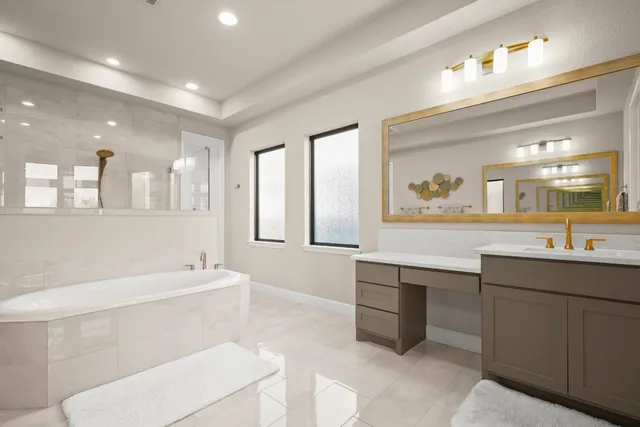 a bathroom with a sink a large mirror and a bathtub