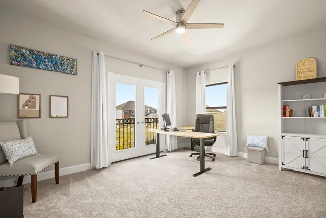 a view of a livingroom with workspace and a window