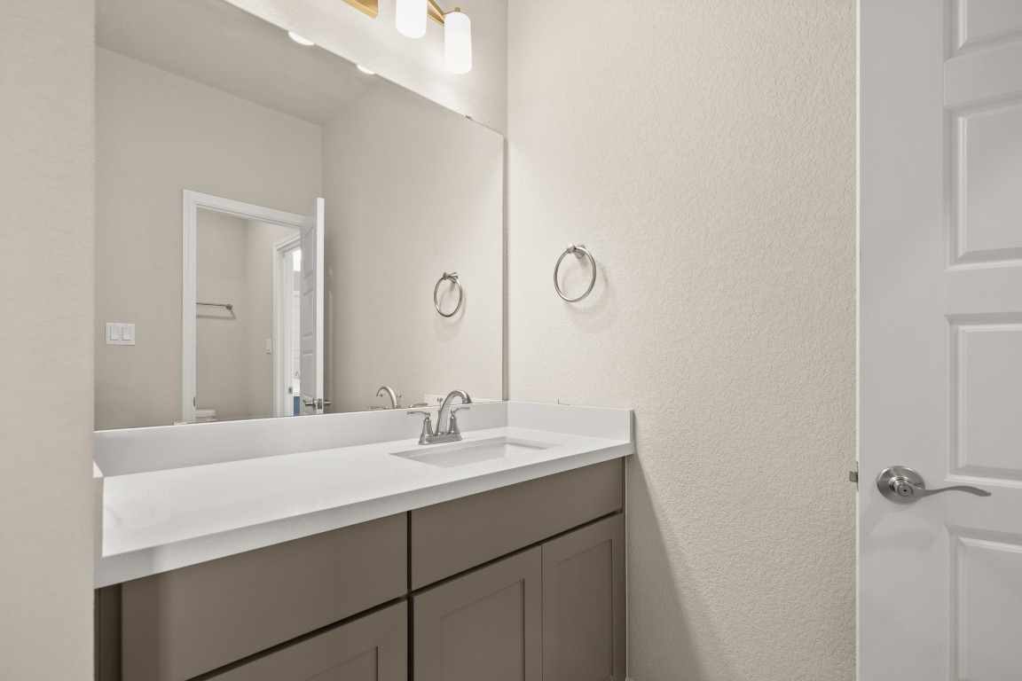 108 Rosetta Loop Liberty Hill, TX 78642 - Photo 28 of 40 a bathroom with a sink and a mirror