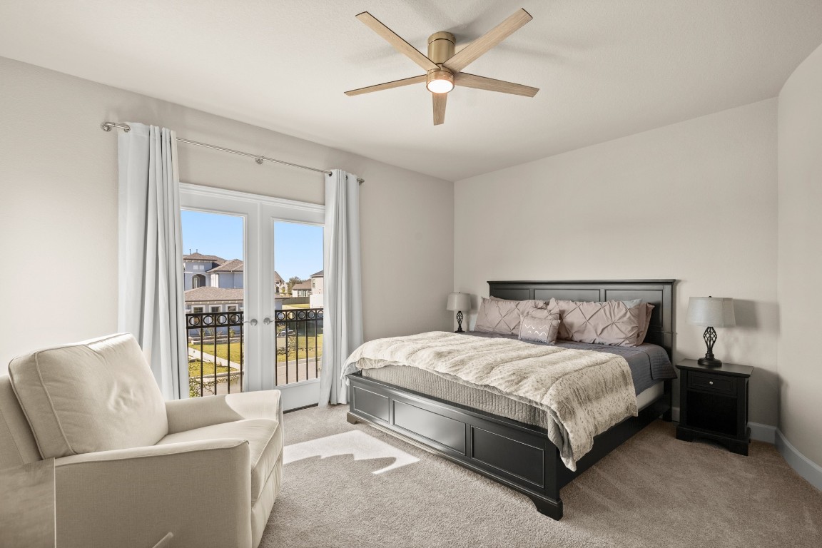 108 Rosetta Loop Liberty Hill, TX 78642 - Photo 33 of 40 a bedroom with a bed couch and a large window