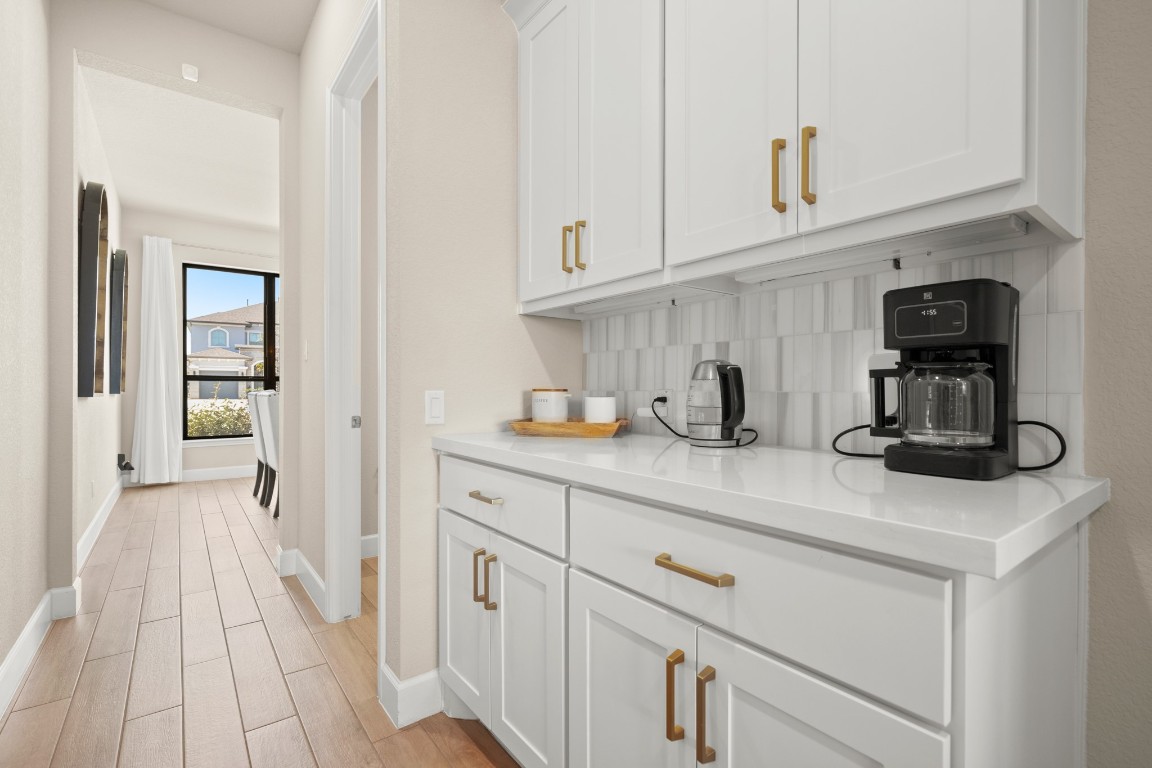 108 Rosetta Loop Liberty Hill, TX 78642 - Photo 38 of 40 a kitchen with white cabinets and sink