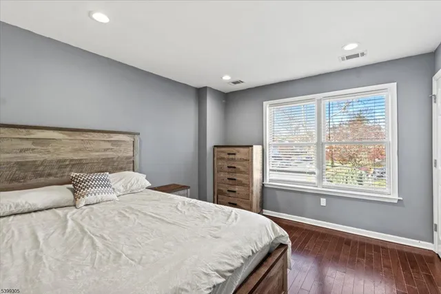 a bedroom with a large bed and a window