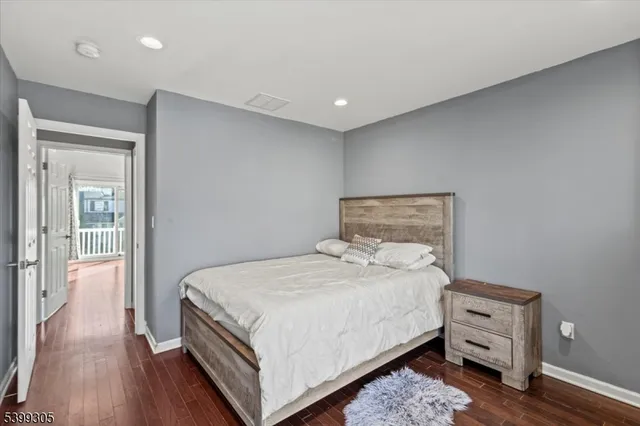 a bedroom with a bed and a night stand