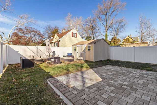 a view of a backyard that has a table and chairs