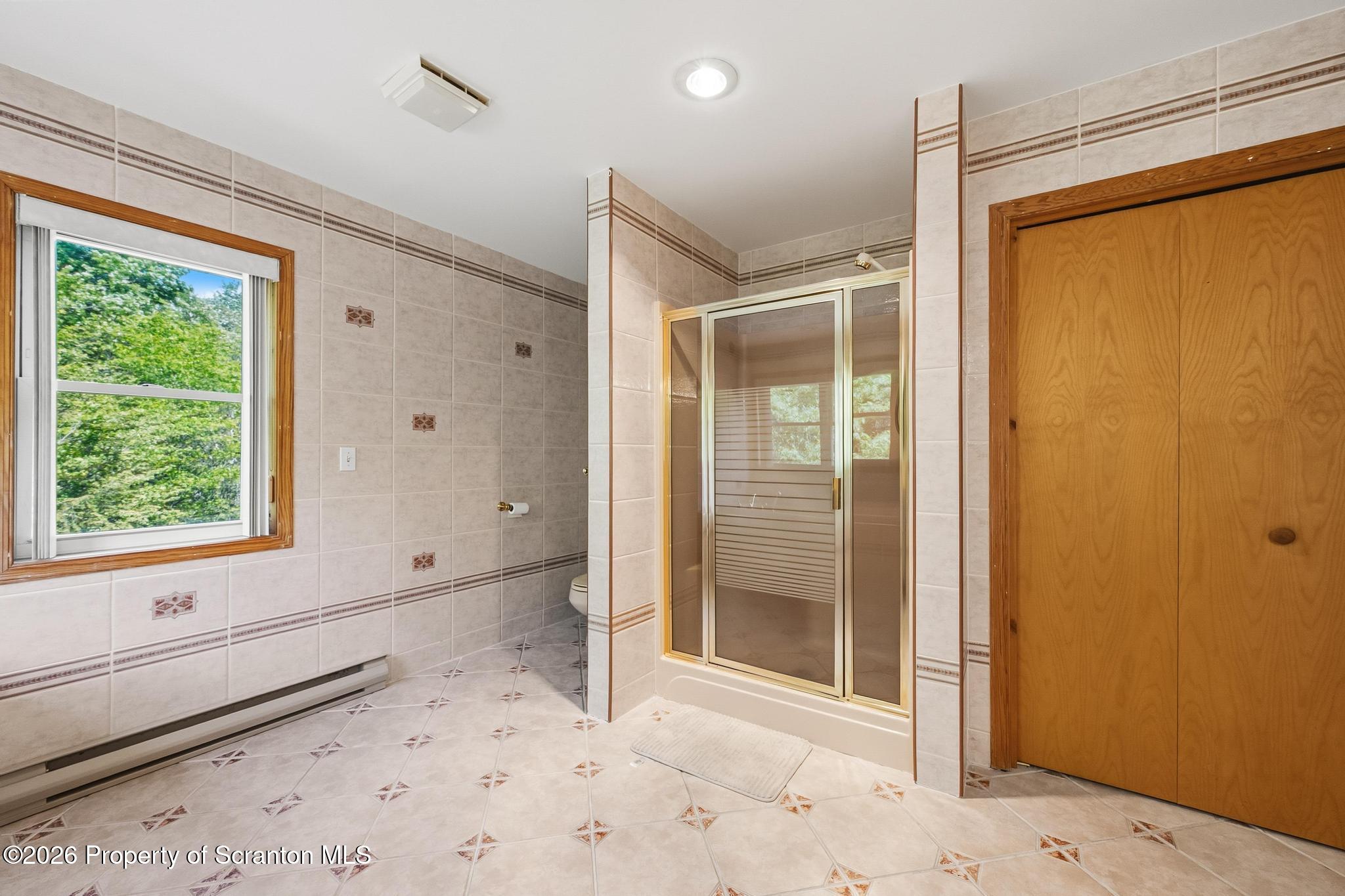 58 Bender Road Gouldsboro, PA 18424 - Photo 23 of 55 a view of a bathroom with a shower and a window