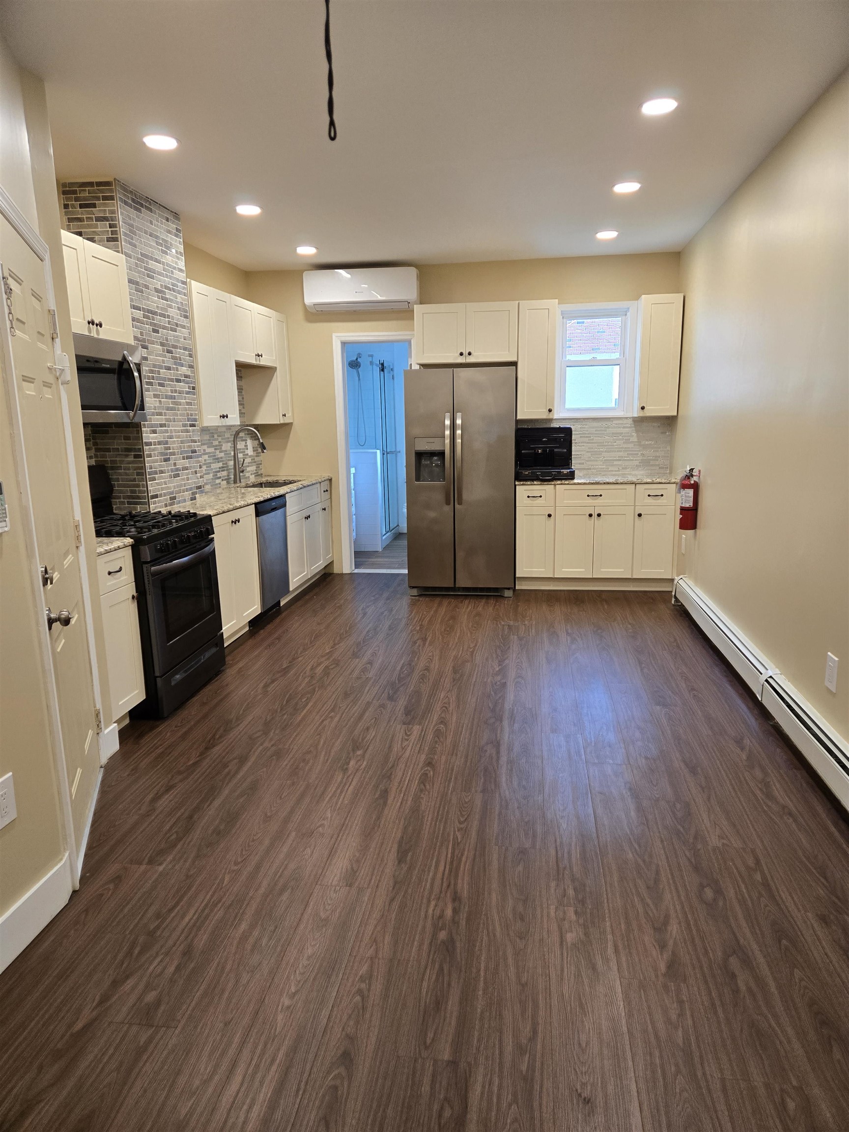 120 68th Street, Unit 1 Guttenberg, NJ 07093 - Photo 2 of 7 a kitchen with stainless steel appliances a refrigerator and a sink