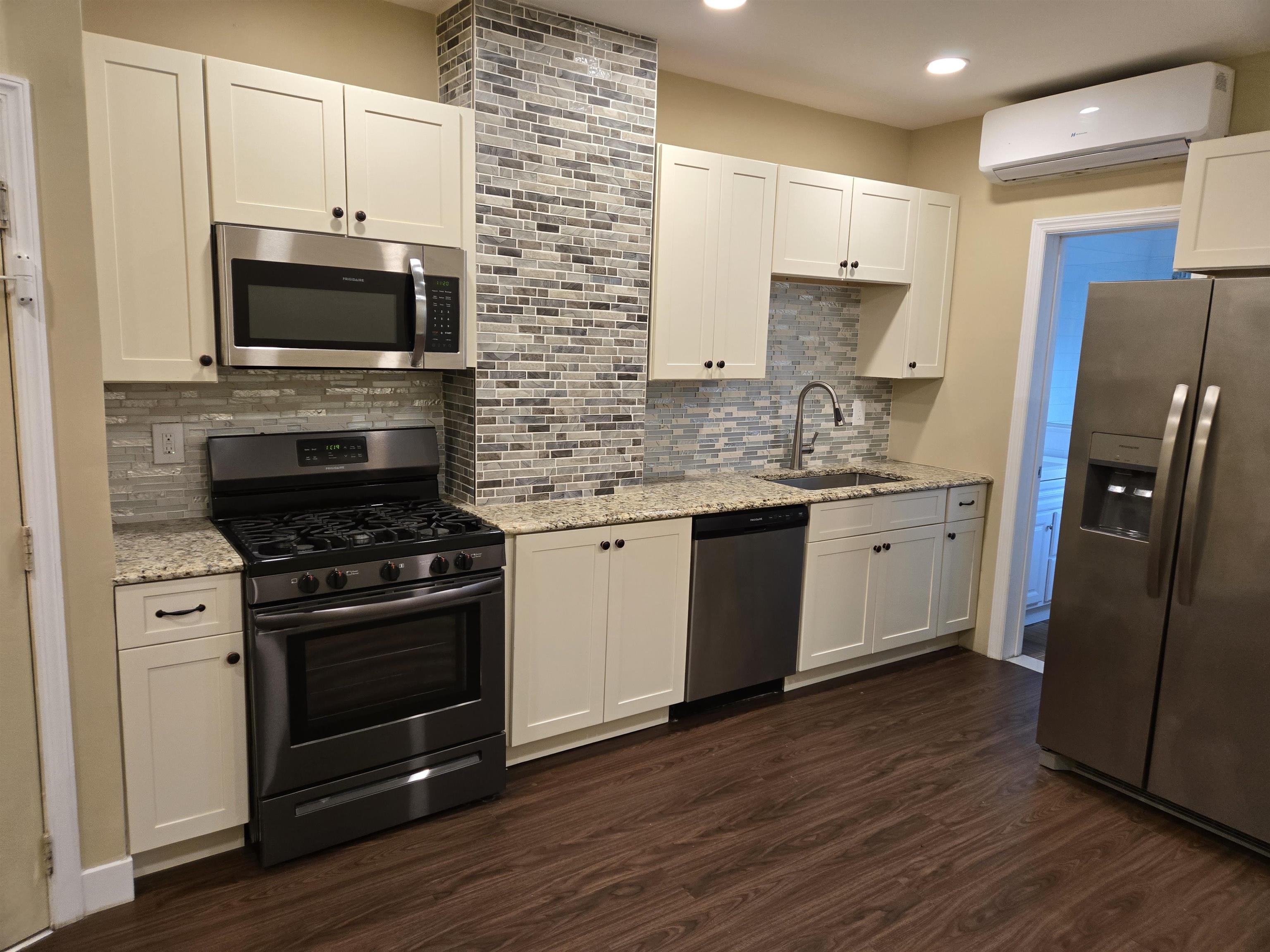 120 68th Street, Unit 1 Guttenberg, NJ 07093 - Photo 3 of 7 a kitchen with stainless steel appliances a stove a sink and a microwave