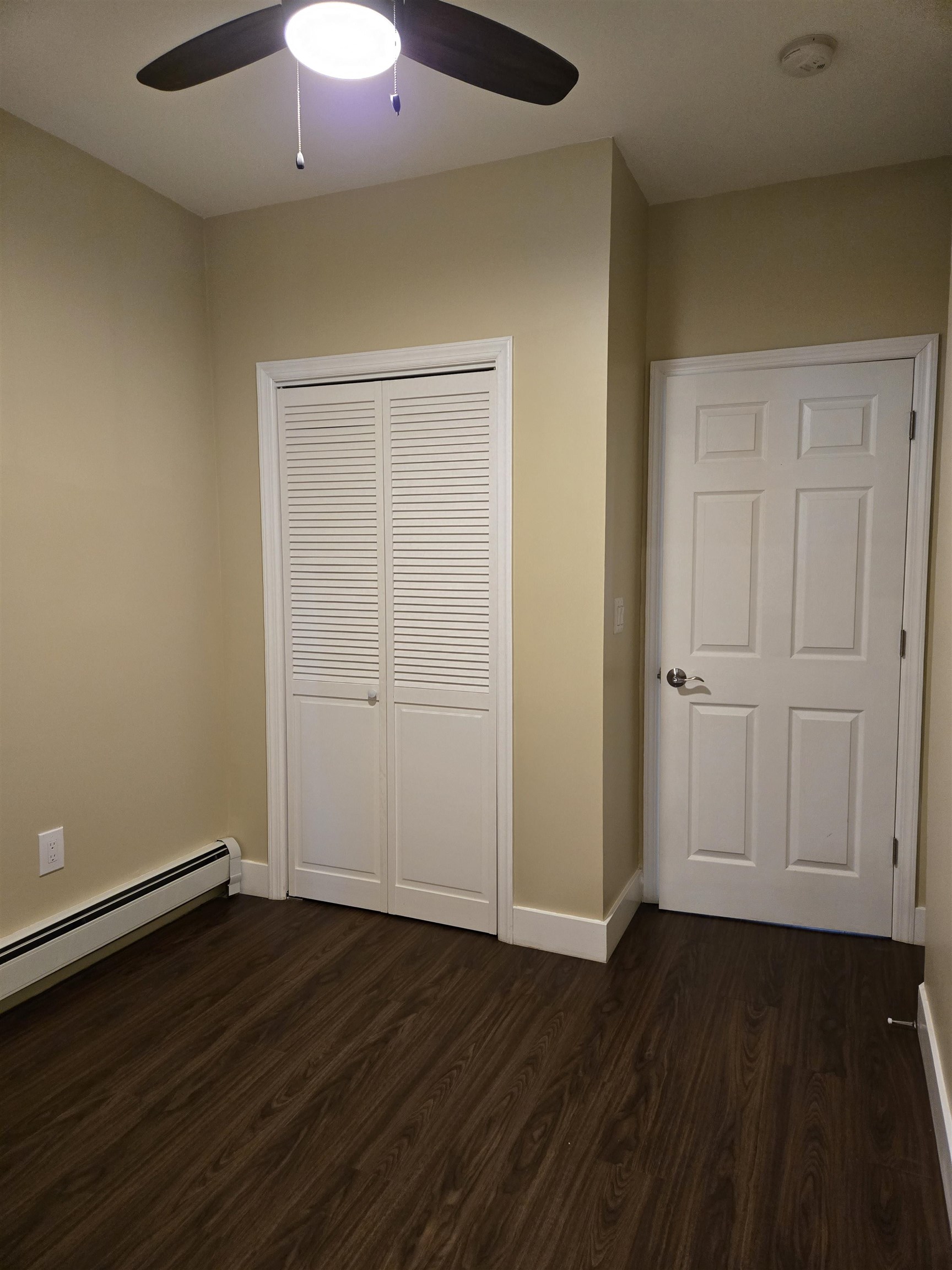 120 68th Street, Unit 1 Guttenberg, NJ 07093 - Photo 6 of 7 an empty room with wooden floor and windows