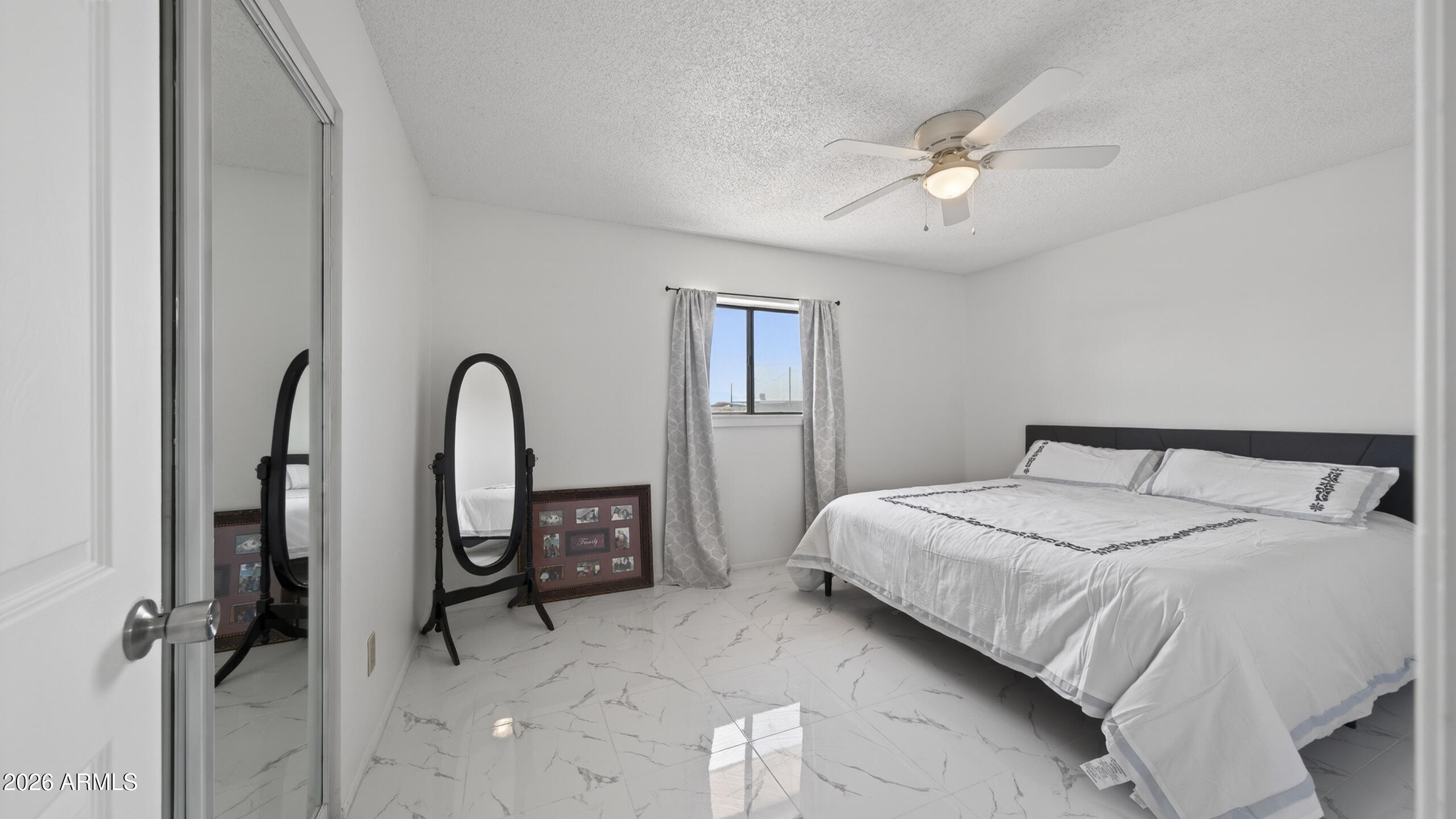 3787 North Joe Hines Road Willcox, AZ 85643 - Photo 27 of 56 a bedroom with a bed and a chandelier