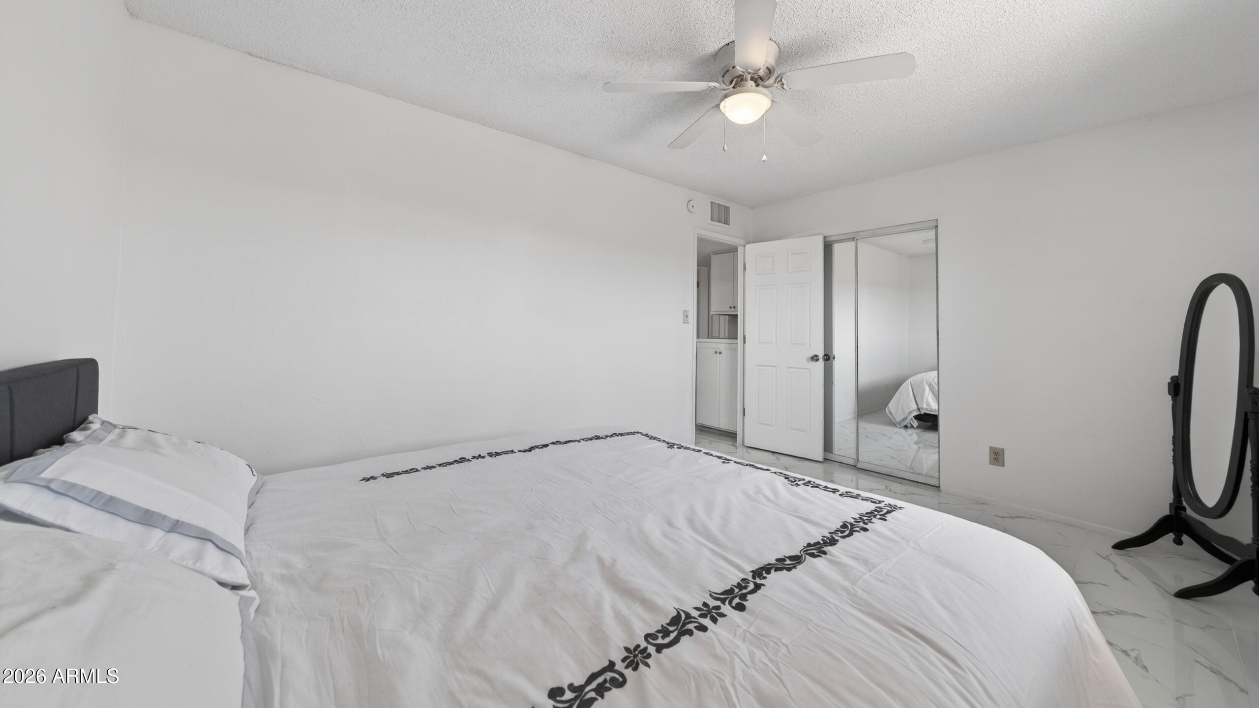 3787 North Joe Hines Road Willcox, AZ 85643 - Photo 28 of 56 a bedroom with a bed and a chandelier