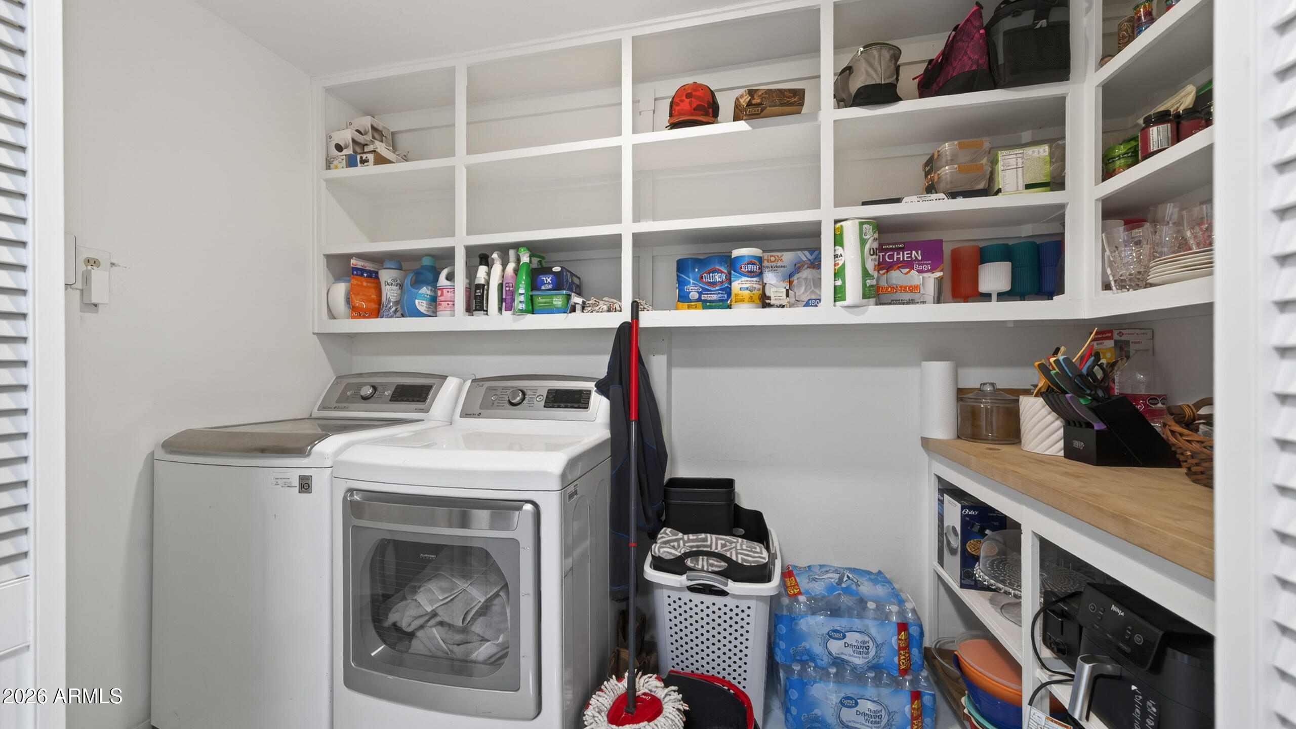 3787 North Joe Hines Road Willcox, AZ 85643 - Photo 36 of 56 a utility room with fridge dryer and bicycles