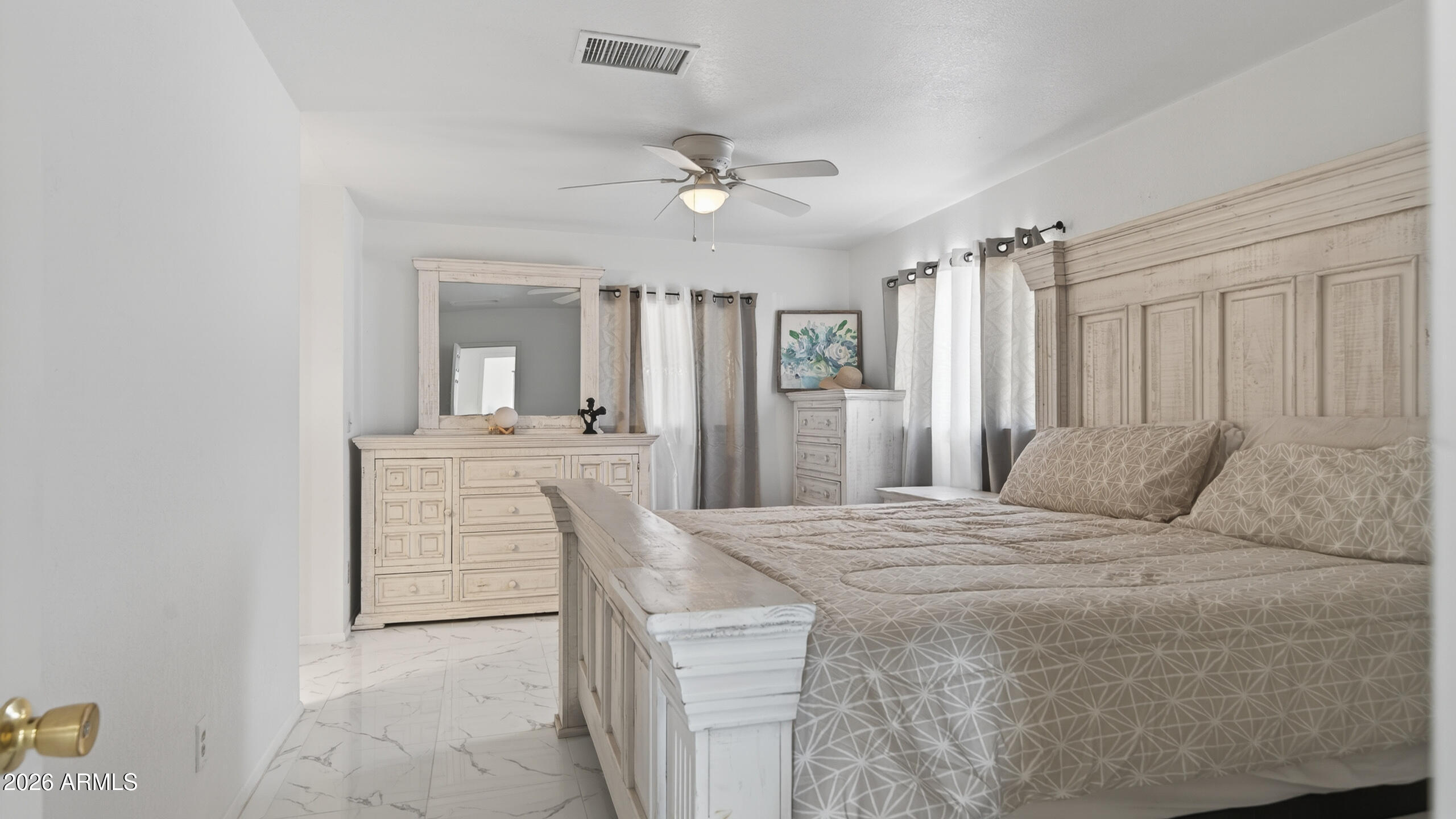 3787 North Joe Hines Road Willcox, AZ 85643 - Photo 3 of 56 a large bedroom with a bed and a chandelier