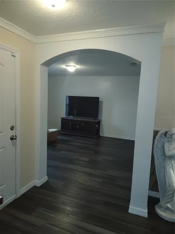 a view of entryway and hall with wooden floor