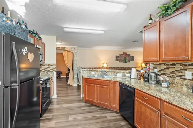a kitchen with stainless steel appliances granite countertop a refrigerator and a sink