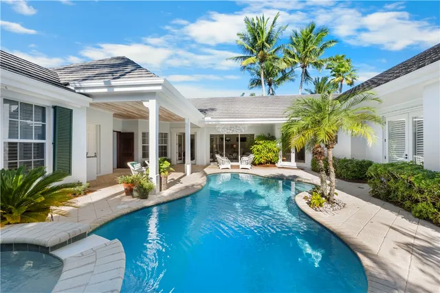 a view of a house with swimming pool and porch with furniture