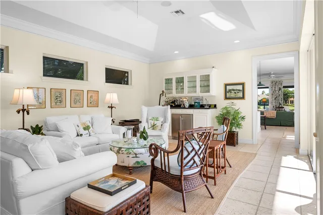 a living room with furniture and a view of kitchen