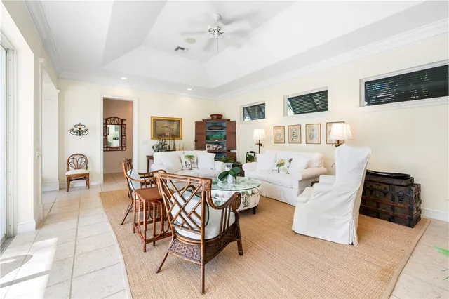 a living room with patio furniture and a flat screen tv
