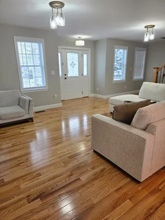 a living room with furniture and a chandelier