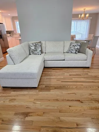 a living room with furniture and a large mirror