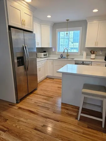 a kitchen with stainless steel appliances a stove a sink a refrigerator and cabinets