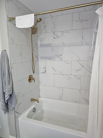 a bathroom with a shower and a shower