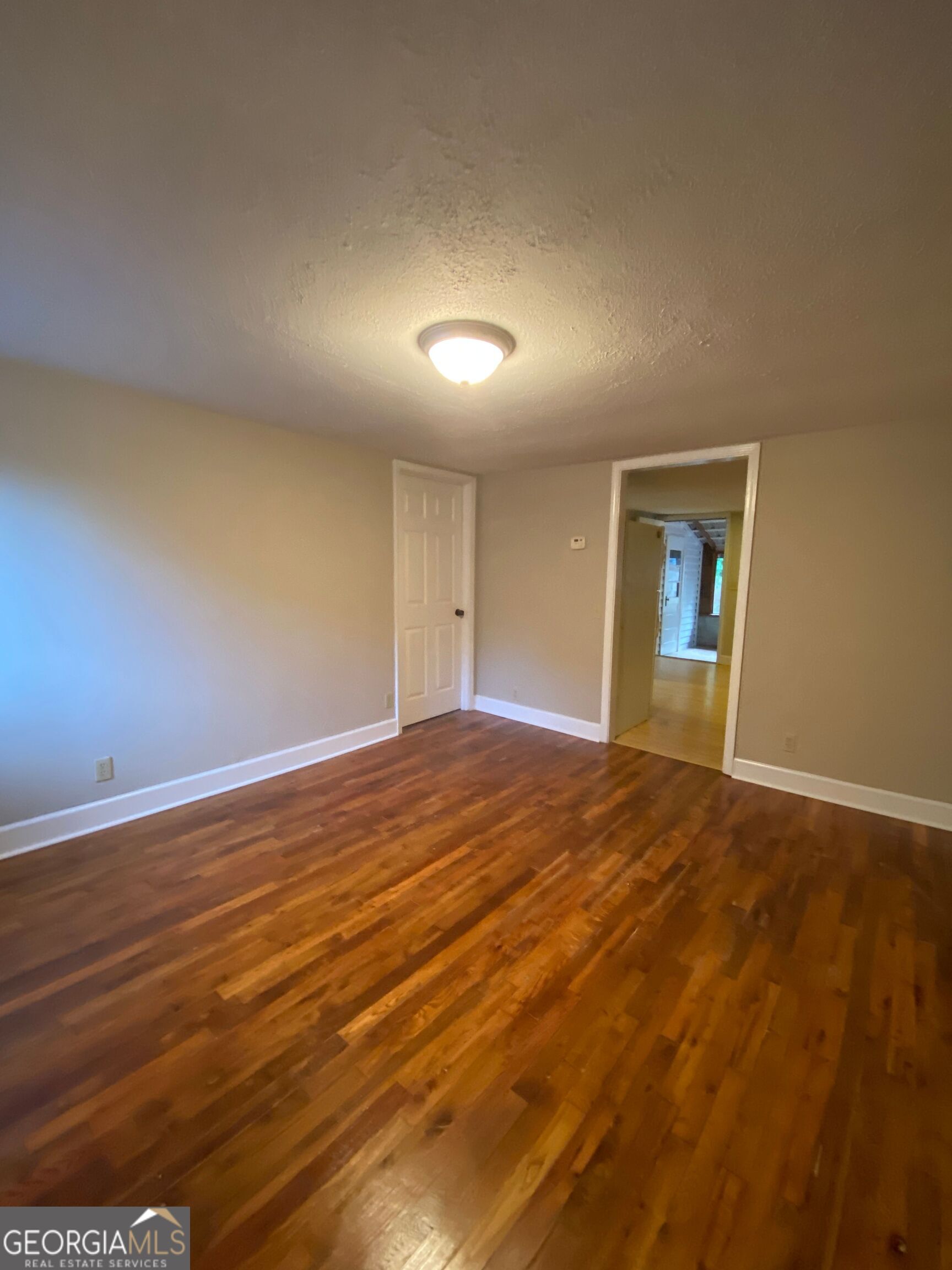 1800 Timothy Road Athens, GA 30606 - Photo 3 of 12 an empty room with wooden floor and windows