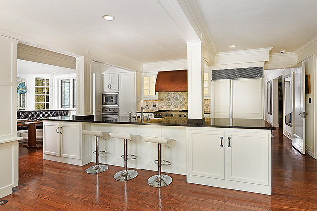 600 Ash Street Winnetka, IL 60093 - Photo 24 of 56 a large white kitchen with granite countertop a stove and white cabinets