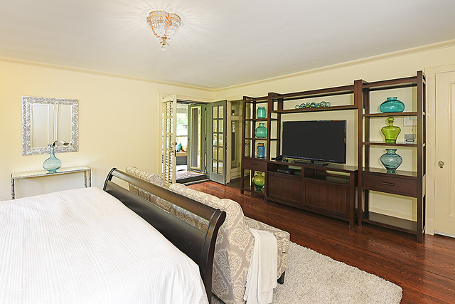 600 Ash Street Winnetka, IL 60093 - Photo 34 of 56 a bedroom with a bed and a flat screen tv