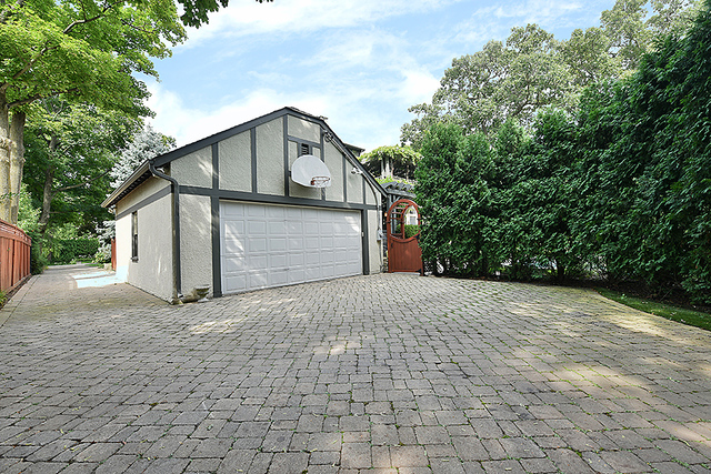 600 Ash Street Winnetka, IL 60093 - Photo 49 of 56 a view of a house with a yard and garage