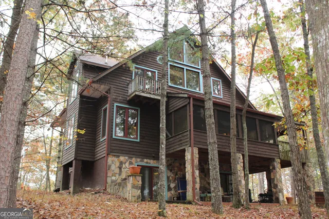 a front view of a house with a tree