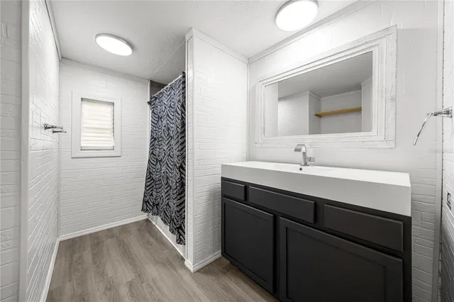 a bathroom with a sink a toilet a shower and a mirror