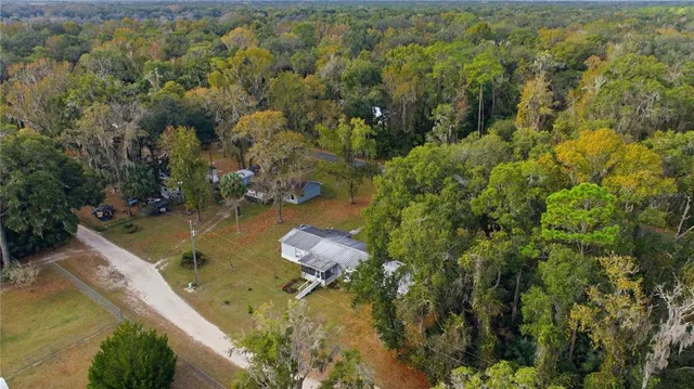 an aerial view of a house with a yard