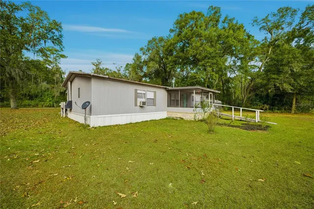 a view of a house with a backyard
