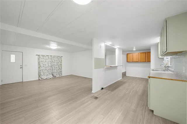 a view of a kitchen with a sink and a microwave