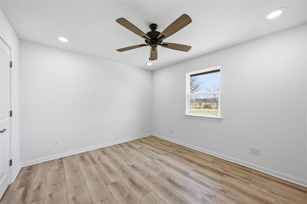 2303 Pilgrim Lane Lorena, TX 76655 - Photo 13 of 38 an empty room with ceiling fan and window