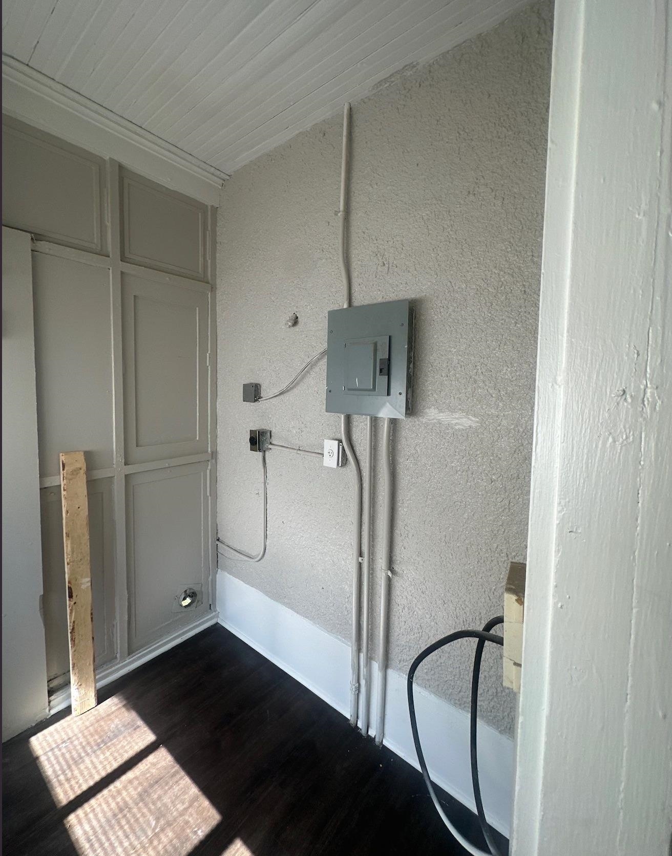 1165 Rayner Street Memphis, TN 38106 - Photo 10 of 16 Utility area featuring a visible electrical panel, dark wood-finish flooring, and white beadboard ceiling