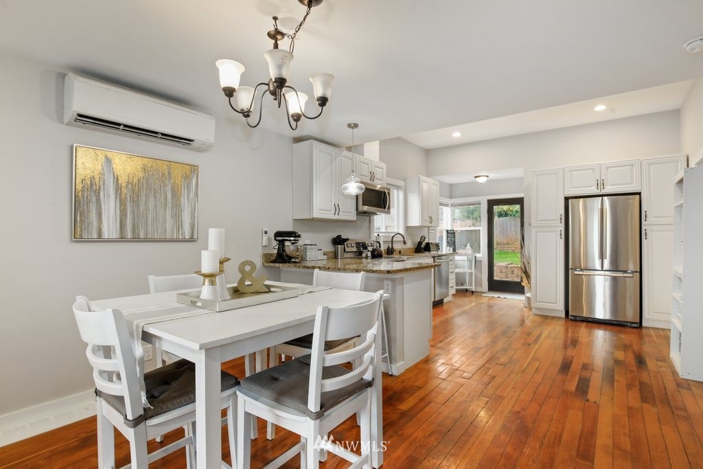 604 Southwest Sunset Boulevard Renton, WA 98057 - Photo 6 of 26 a kitchen with stainless steel appliances a dining table and chairs
