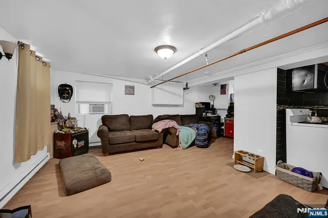 a living room with furniture gym equipment and a flat screen tv