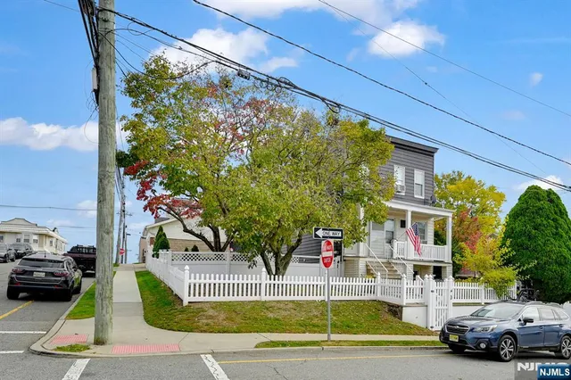 a view of a cars park in front of a house