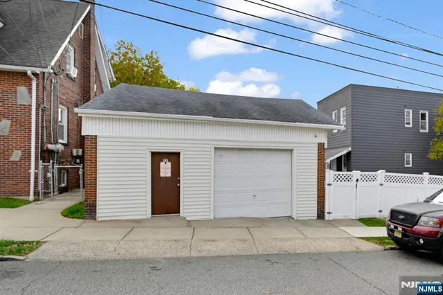 a view of a car parked front of a house