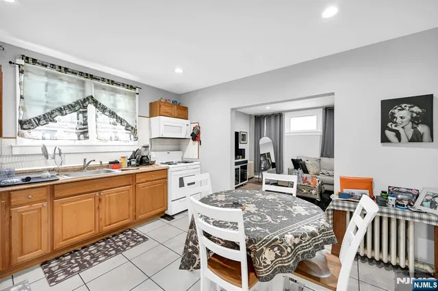 a large kitchen with a table and chairs in it