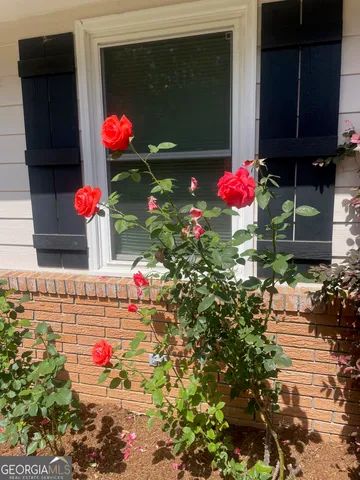 a view of front door of the house and flowers