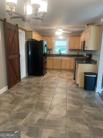 a kitchen with stainless steel appliances granite countertop a refrigerator and a sink