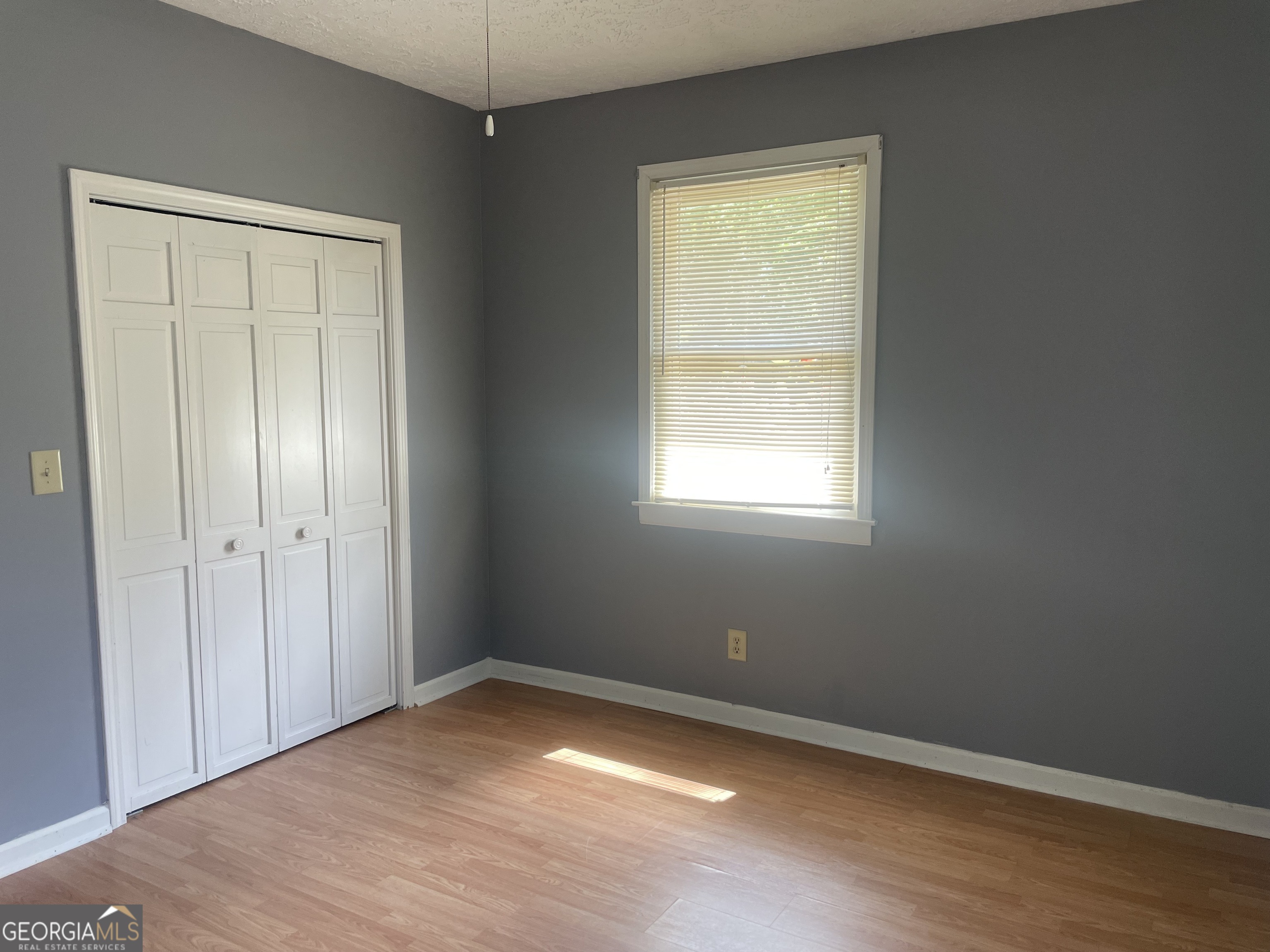 215 Old Mize Road Toccoa, GA 30577 - Photo 22 of 43 a view of an empty room with wooden floor and a window