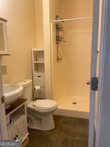 a bathroom with a toilet and a shower