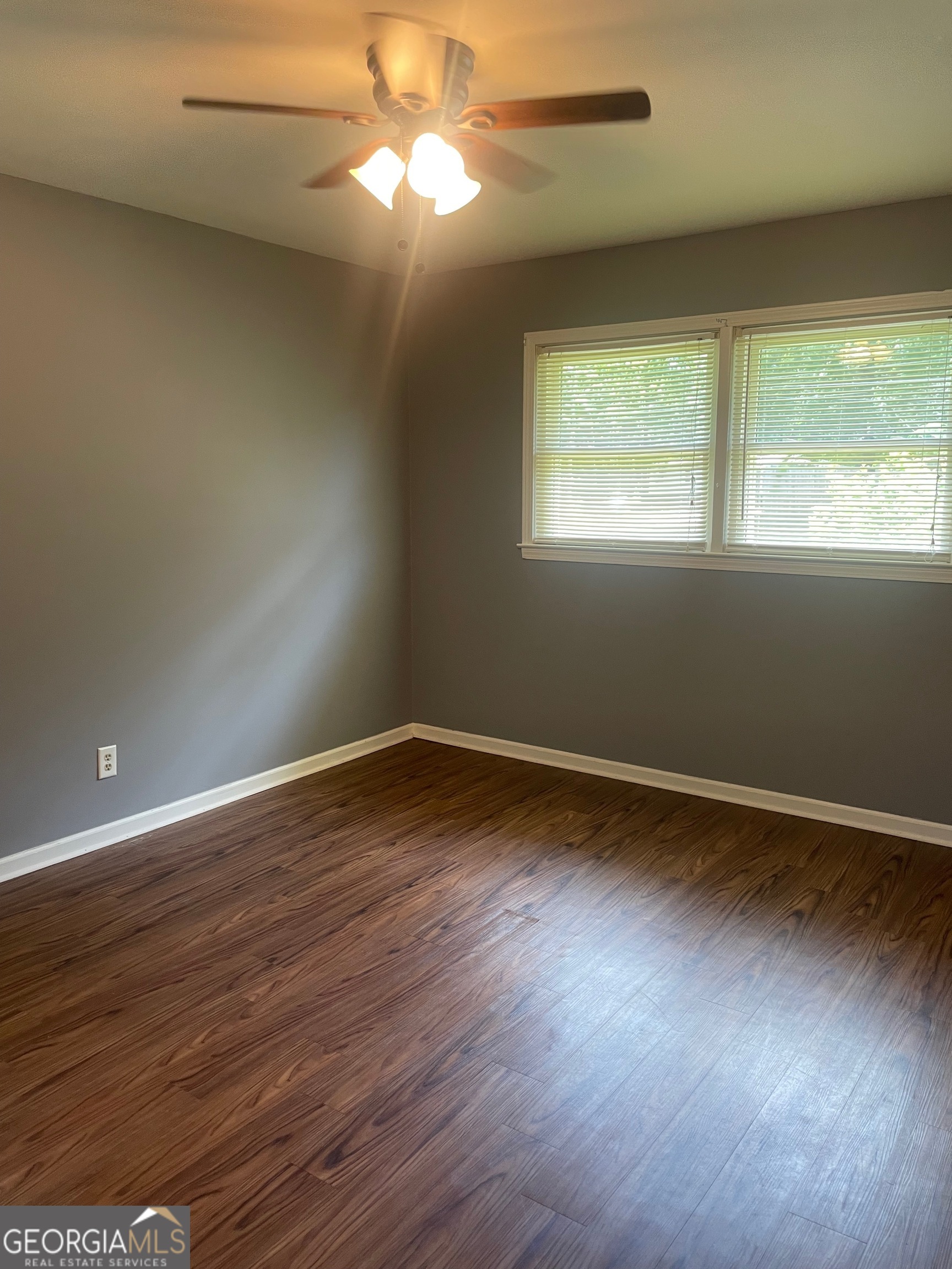 215 Old Mize Road Toccoa, GA 30577 - Photo 29 of 43 an empty room with wooden floor and windows