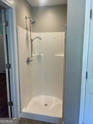 a bathroom with a glass shower door