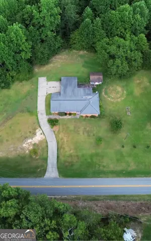 an aerial view of a house with a yard