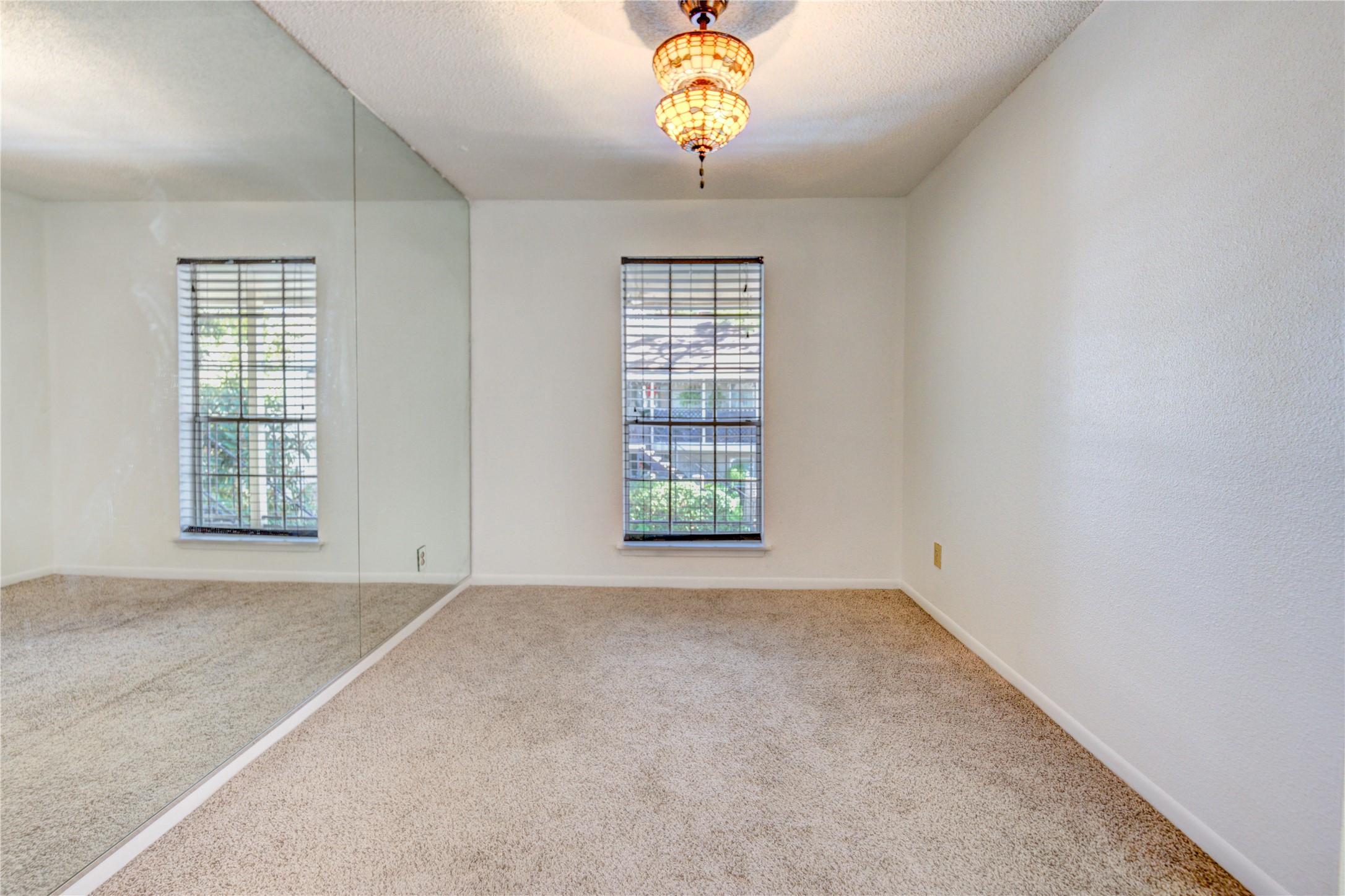 2800 Jeanetta Street, Unit 2504 Houston, TX 77063 - Photo 18 of 49 an empty room with windows and chandelier fan